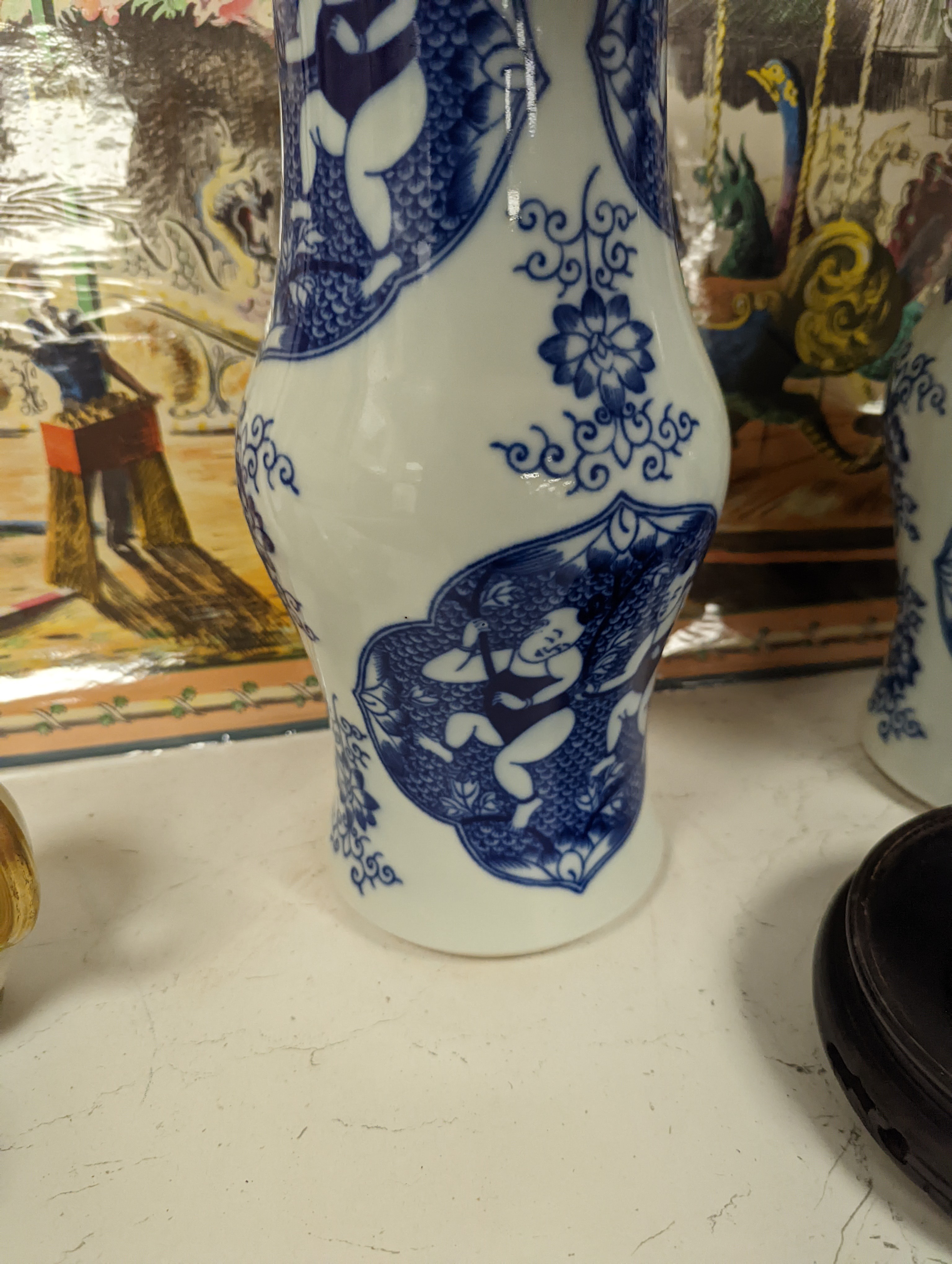 A pair of Chinese blue and white vases on stands and 4 further wood stands. Vases 35cm